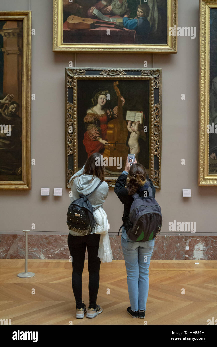 tourists photographing paintings with mobile phone at Louvre museum, paris, France Stock Photo