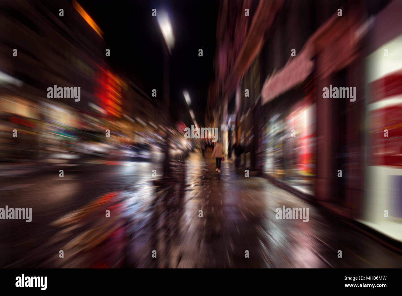 Blurry motion image of people walking on street at night in Paris Stock ...
