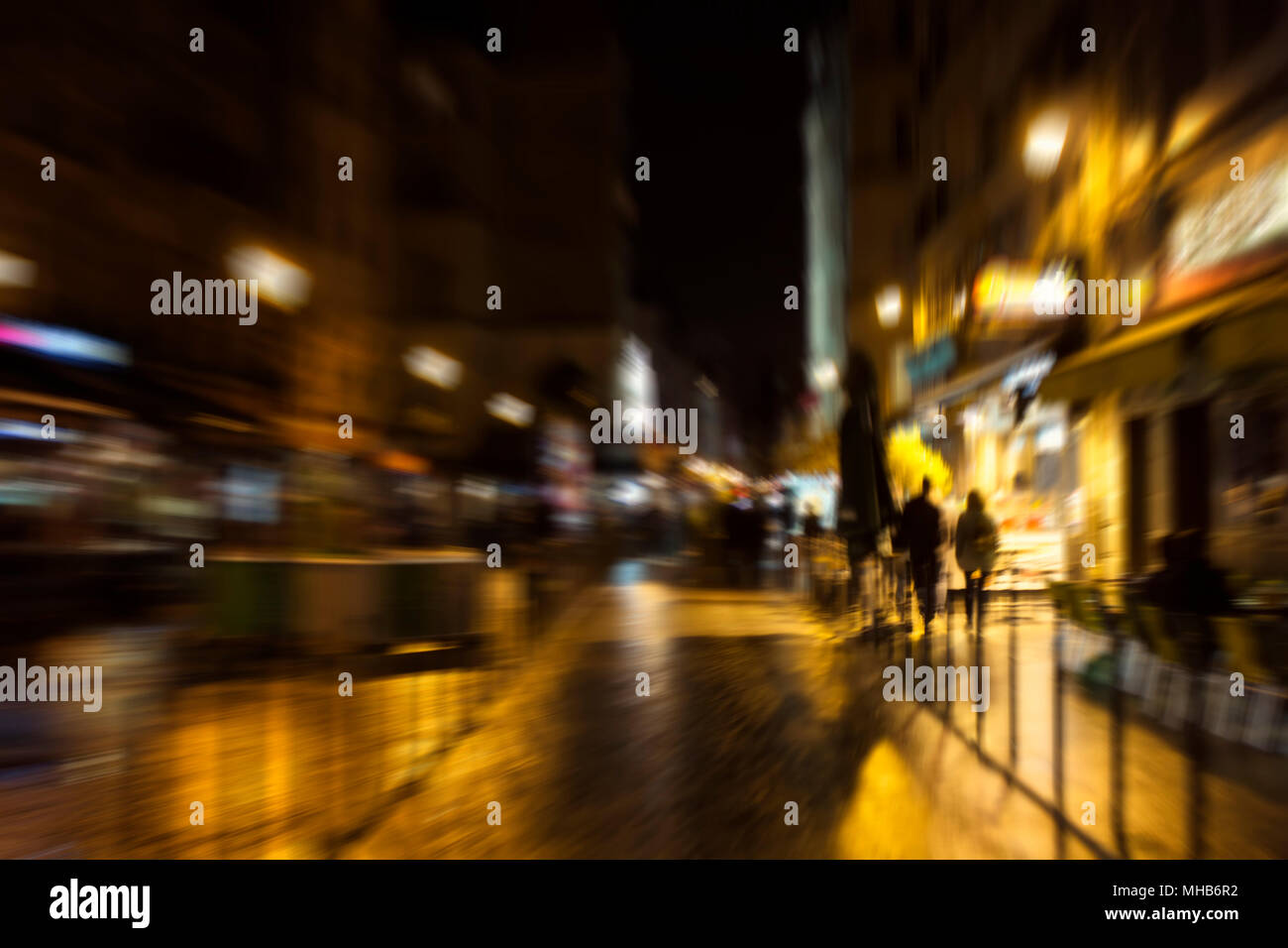 Blurry motion image of people walking on street at night in Paris Stock ...