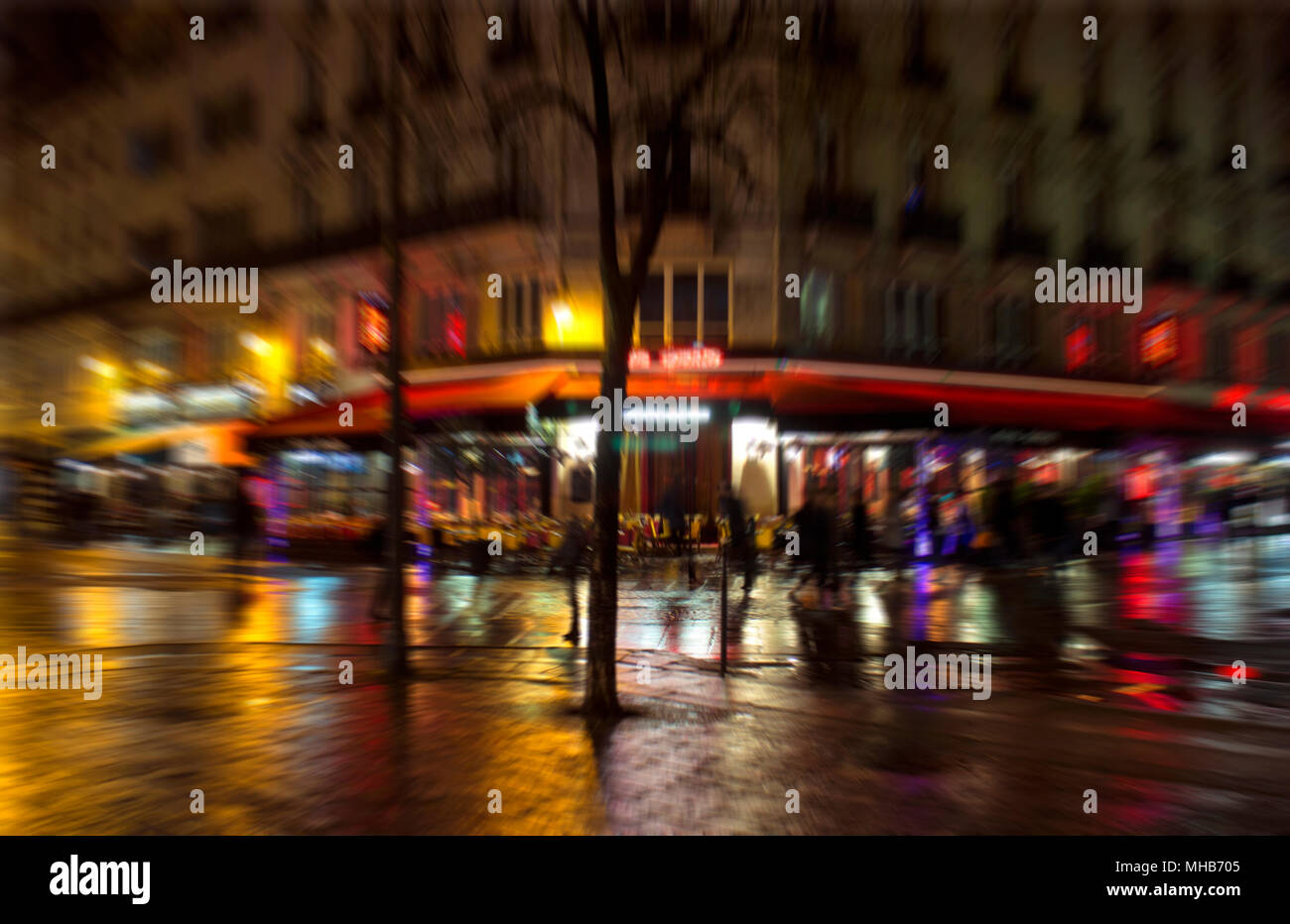 Blurry motion image of people walking on street at night in Paris Stock ...