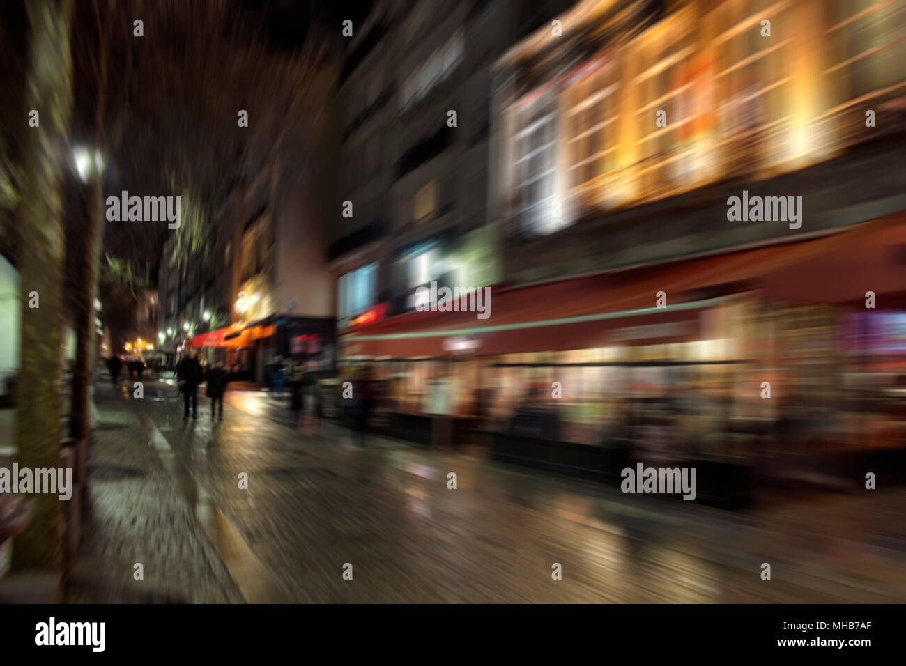 Blurry motion image of people walking on street at night in Paris Stock ...