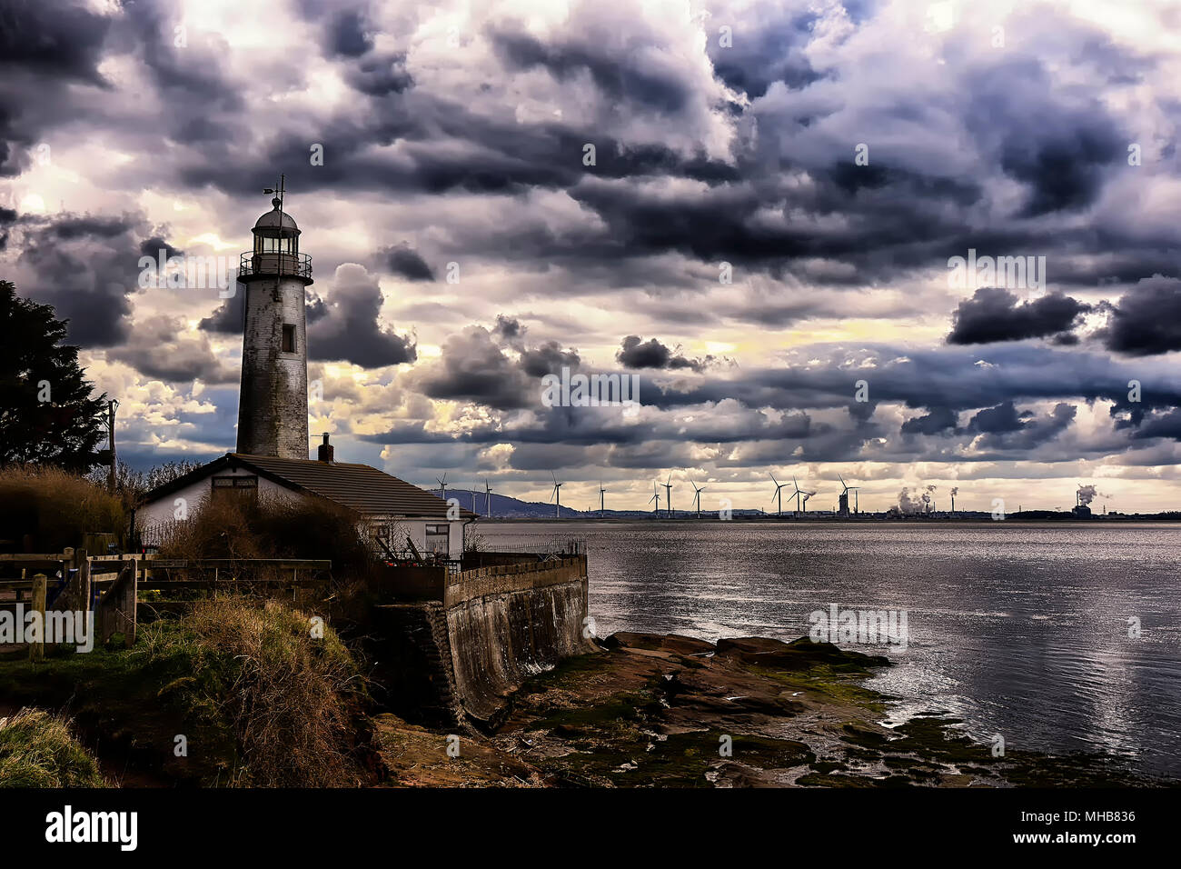 old Lighthouse with storm clouds. Hale head lighthouse Liverpool, Merseyside. Stock Photo