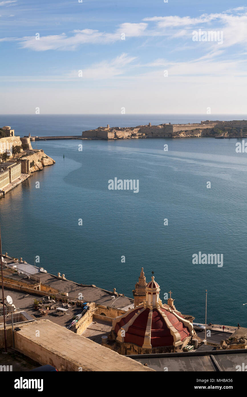 Maltese people and visitors alike gather at Tivoli gardens at sunset to admire the view and find a quiet moment. Valletta, Malta Stock Photo