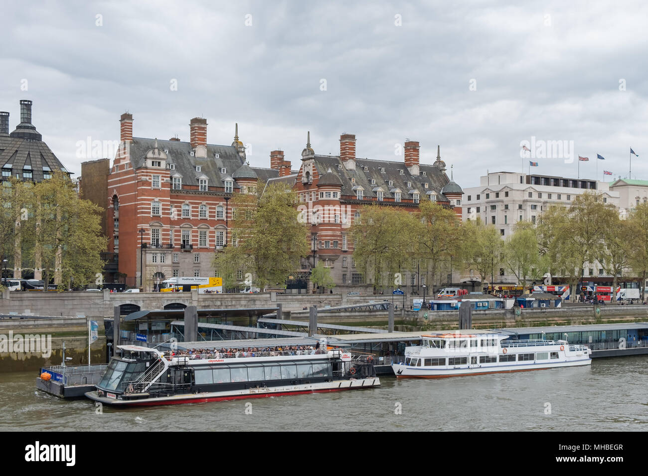 Sightseeing boats moored along the Thames River in London near the Westminster Bridge. Stock Photo