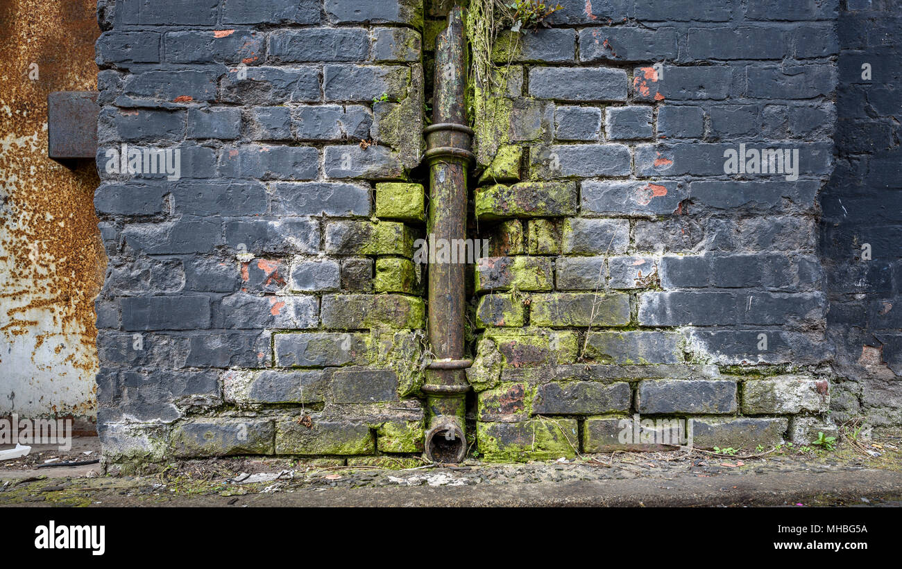 Grungy old neglected drain pipe gutter. Stock Photo
