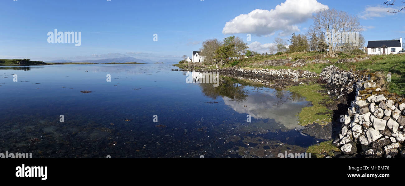 Calm waters of Ob Bhreacais and coastal holiday cottage (extreme right), Lower Breakish, Broadford, Isle of Skye, Scotland, UK Stock Photo