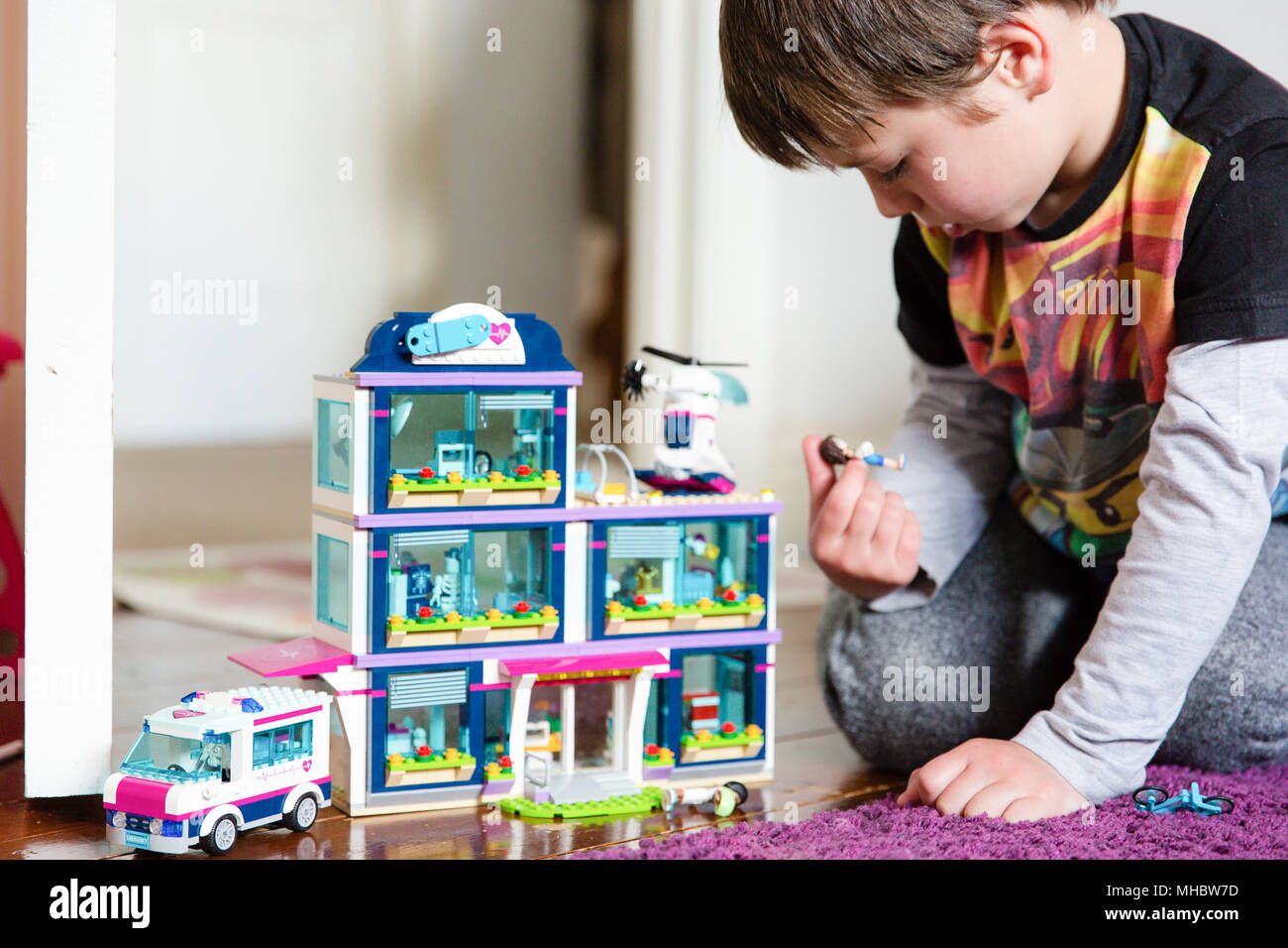 6 years old boy playing with lego hospital set Stock Photo