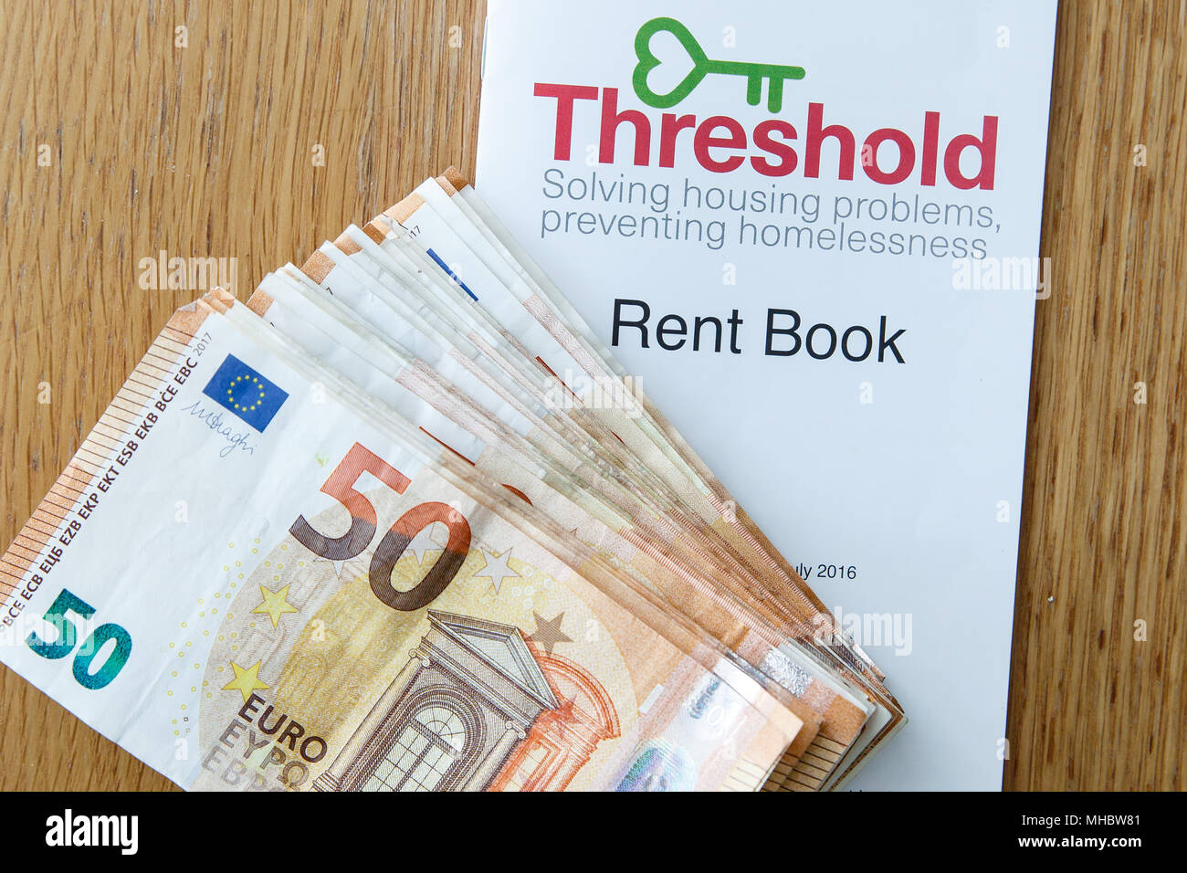 Cash for landlord for rented property and rental book from Threshold. Housing crisis. Cost of living in Ireland rising as rents continue to increase. Stock Photo