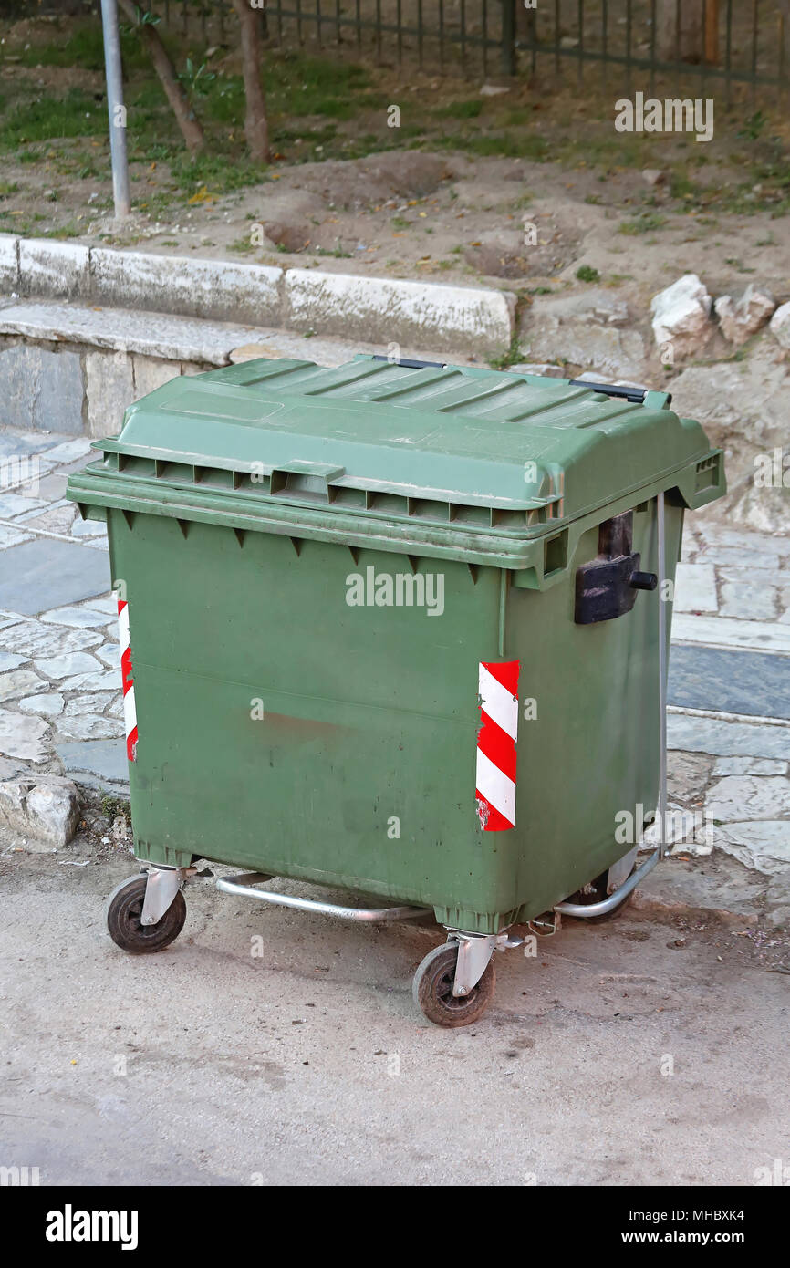 https://c8.alamy.com/comp/MHBXK4/green-plastic-garbage-container-with-wheels-MHBXK4.jpg