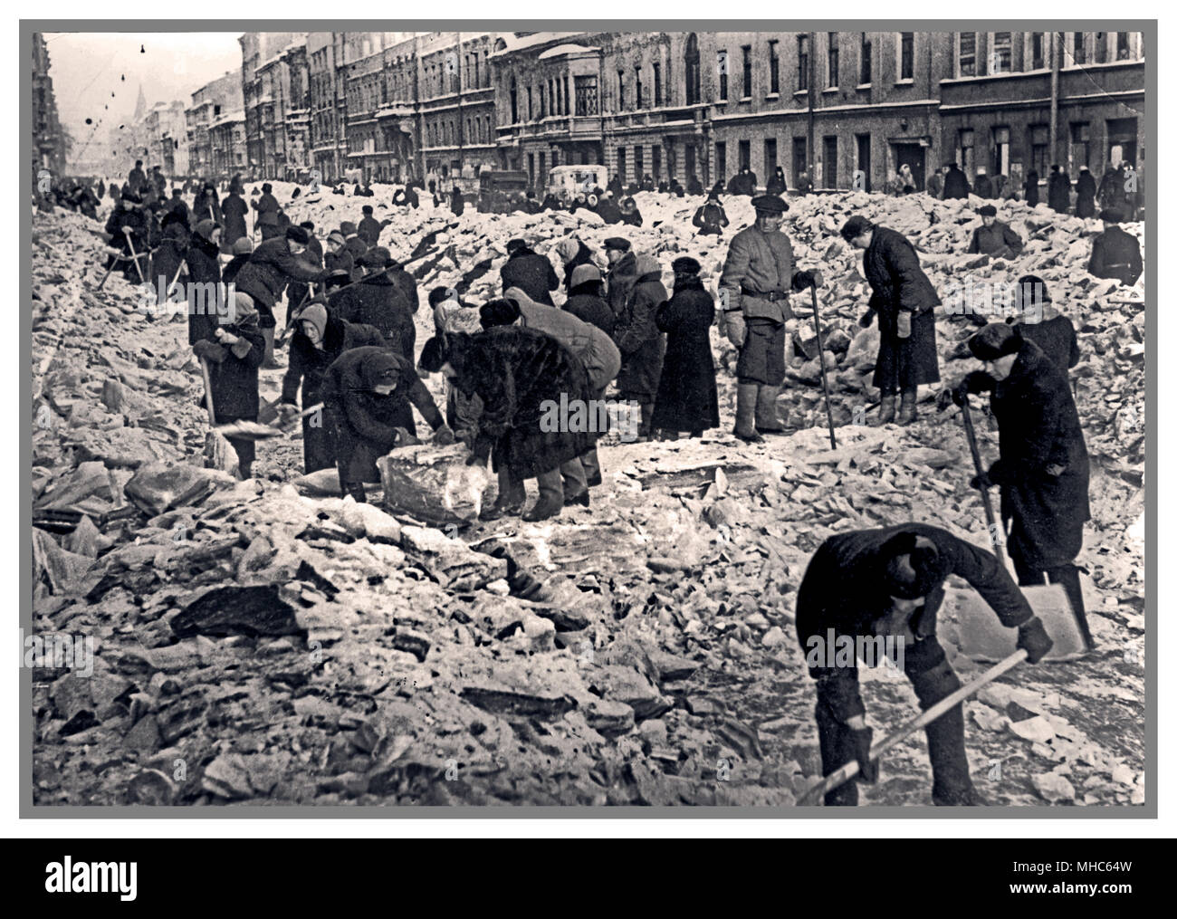Leningrad siege Winter WW2 Residents with shovels clearing snow and ice blocks Nevsky Prospect Leningrad World War 2 Second World War Eastern Front Nazi aggression  1942 Stock Photo