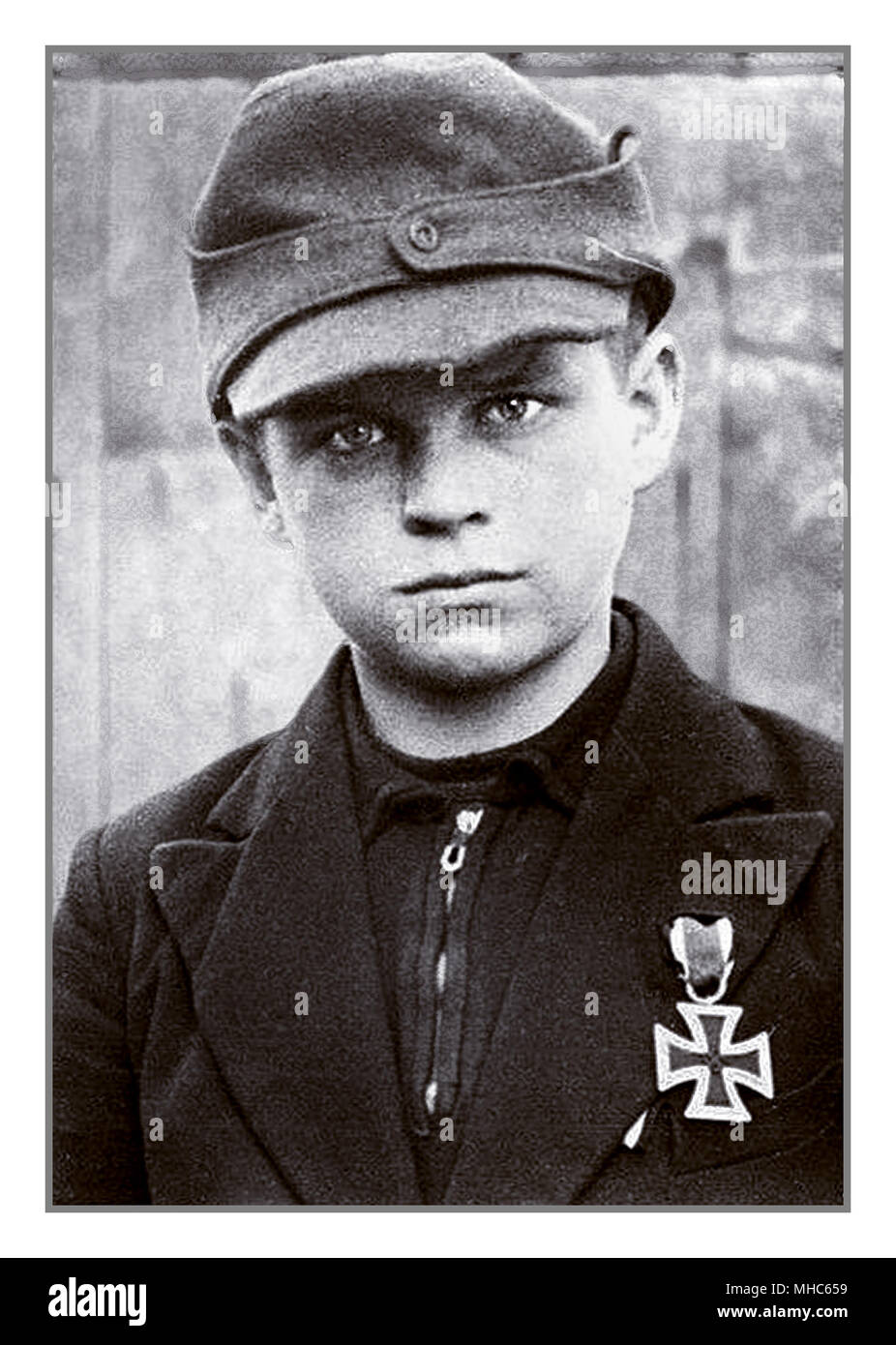 1940’s Photograph Hitler Youth Medal Iron Cross.. Boy 10-12 years of age already presented with an Iron Cross medal for bravery, coming from ranks of Hitler Youth,  despatched with blind faith and misplaced loyalty to defend at any cost Berlin Germany in the last stages of World War II 1945 Stock Photo