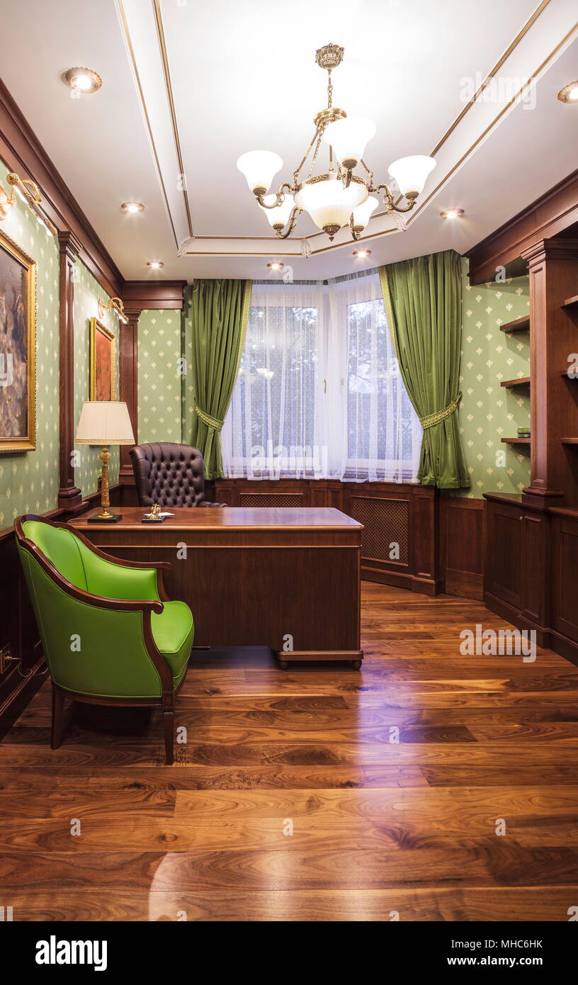 Green armchair in classic interior of cabinet Stock Photo
