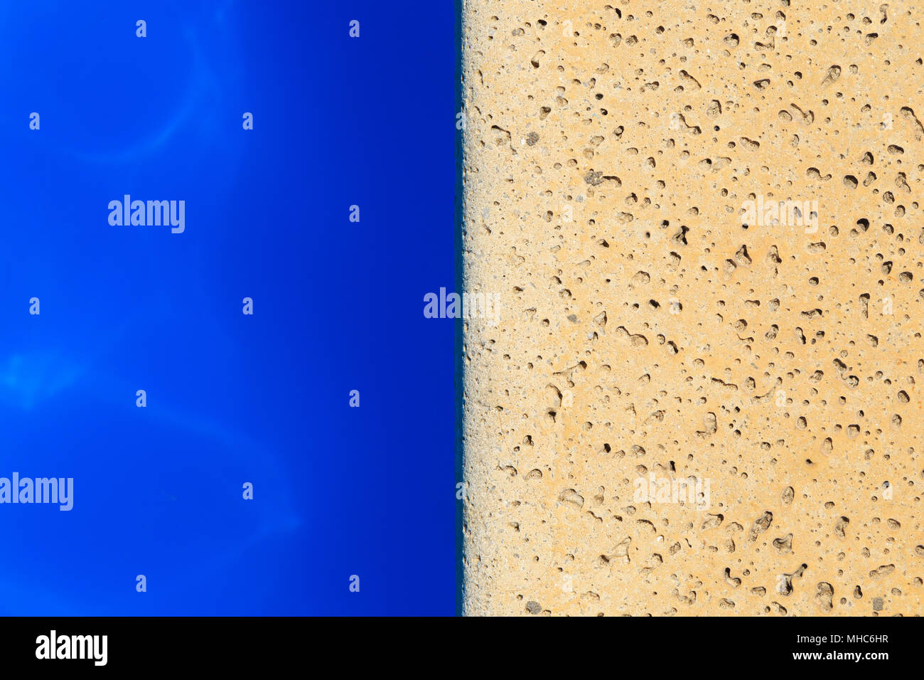 Top view of swimming pool edge. The water and the stone floor. Stock Photo
