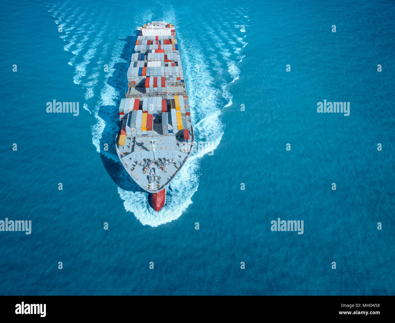 Large container ship is coming to the port full loaded with containers and cargo Stock Photo