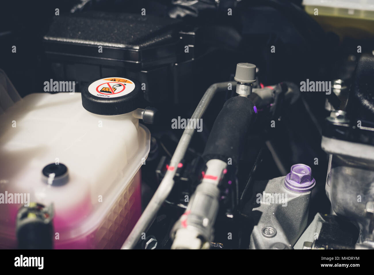 Coolant tank and warning information in engine room Stock Photo