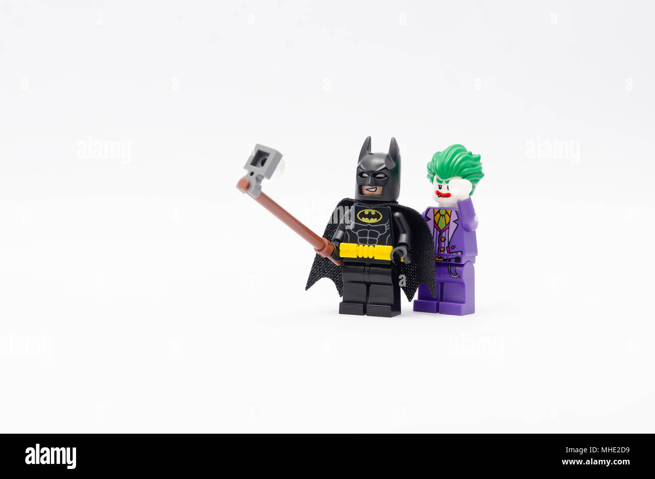 mini figure of batman and joker taking picture together. Lego minifigures are manufactured by The Lego Group. Stock Photo