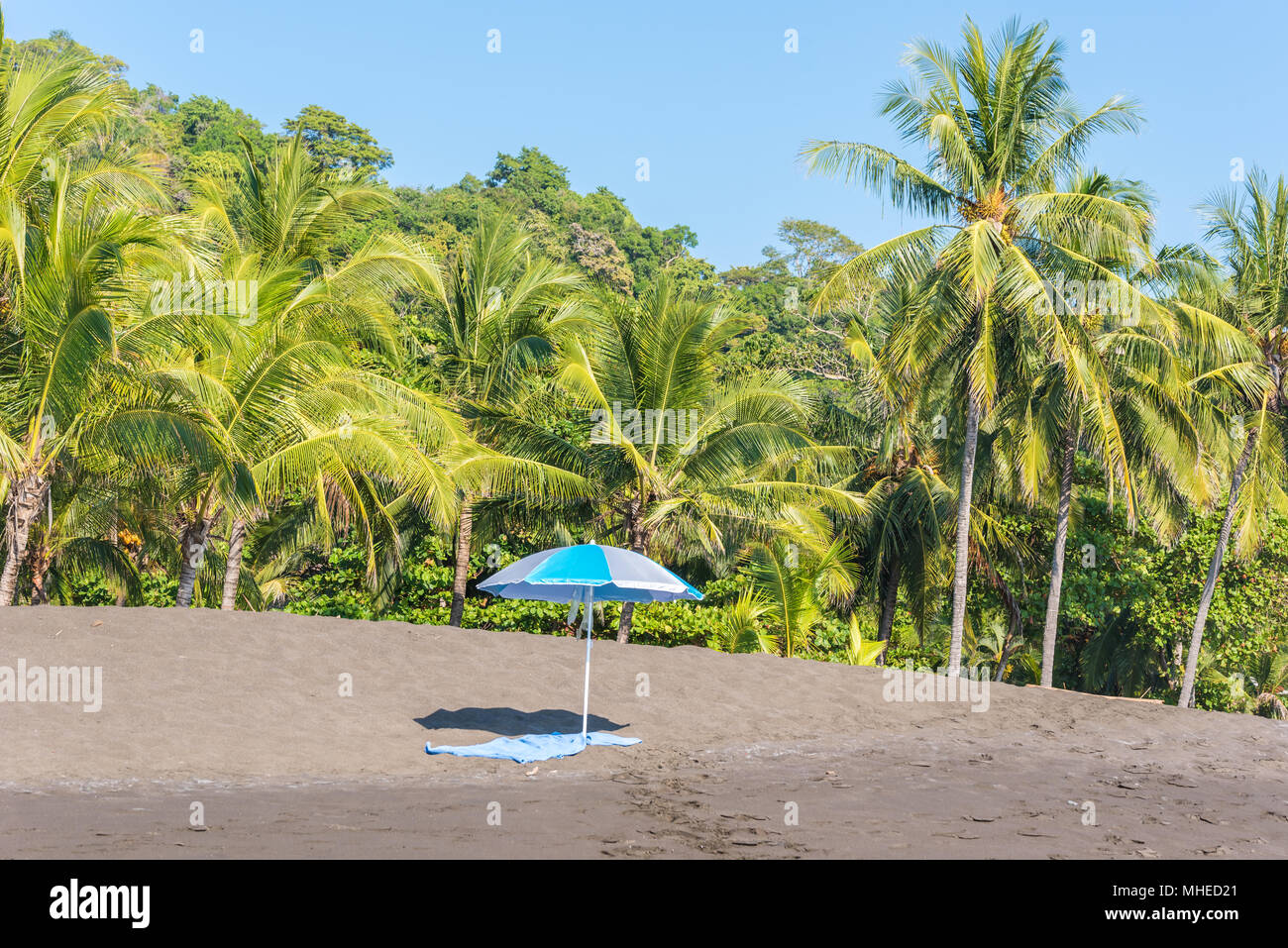 Beach umbrella and towel at playa hermosa en Costa Rica pacific coast