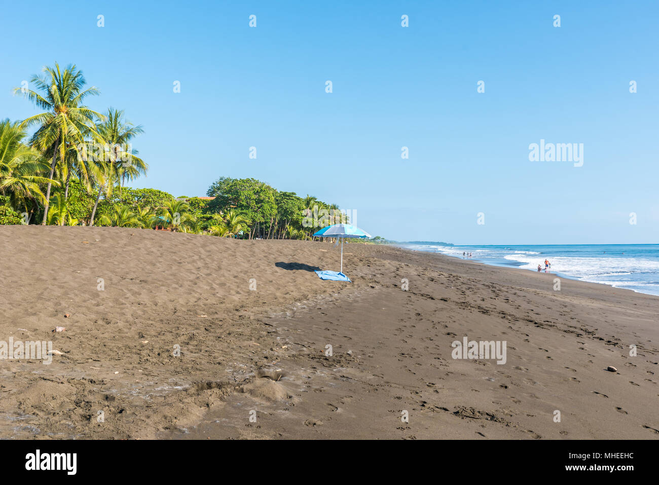 Beach umbrella and towel at playa hermosa en Costa Rica - pacific coast ...