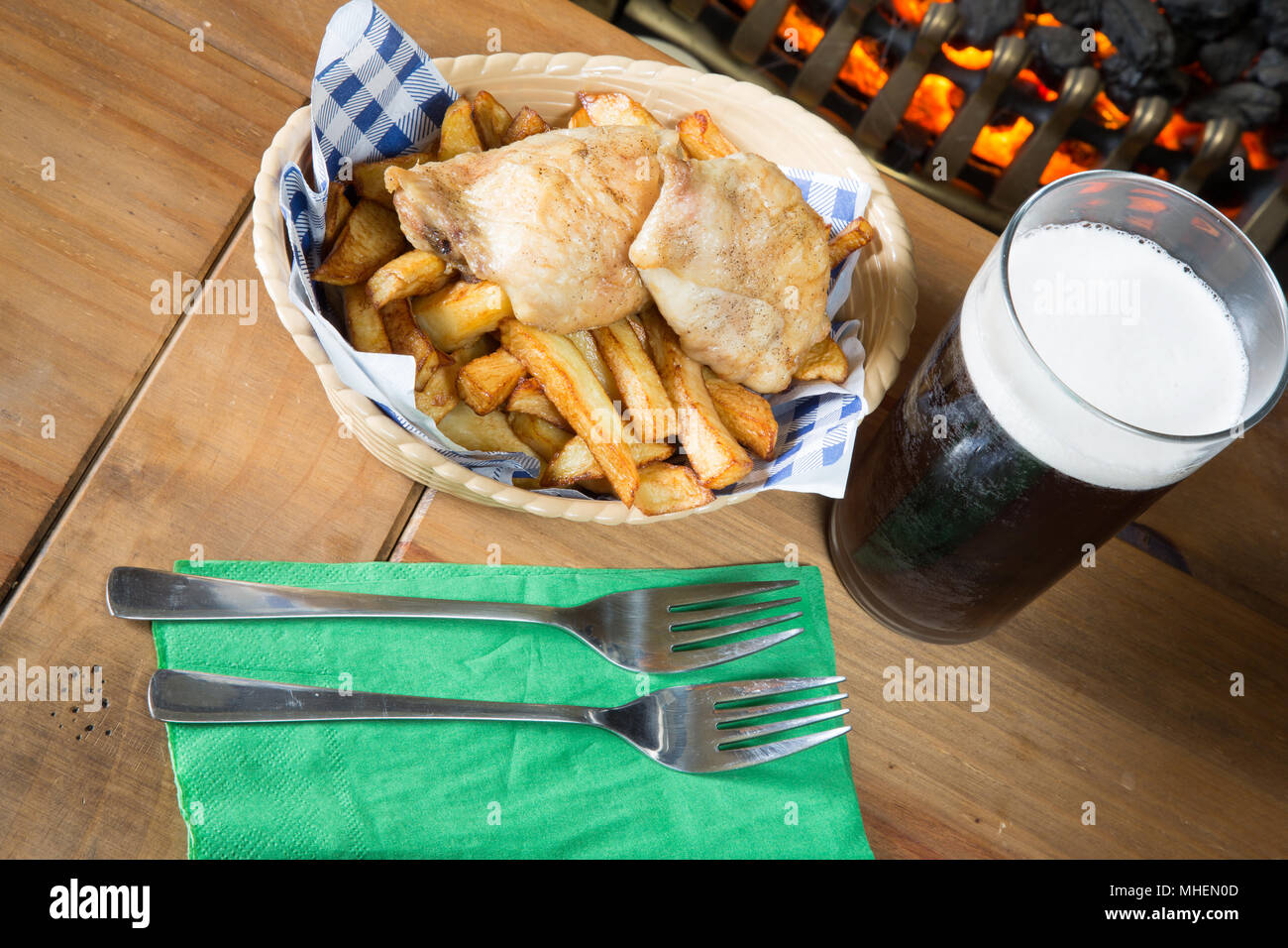 A classic English dish of Roast Chicken and chips in a basket Stock