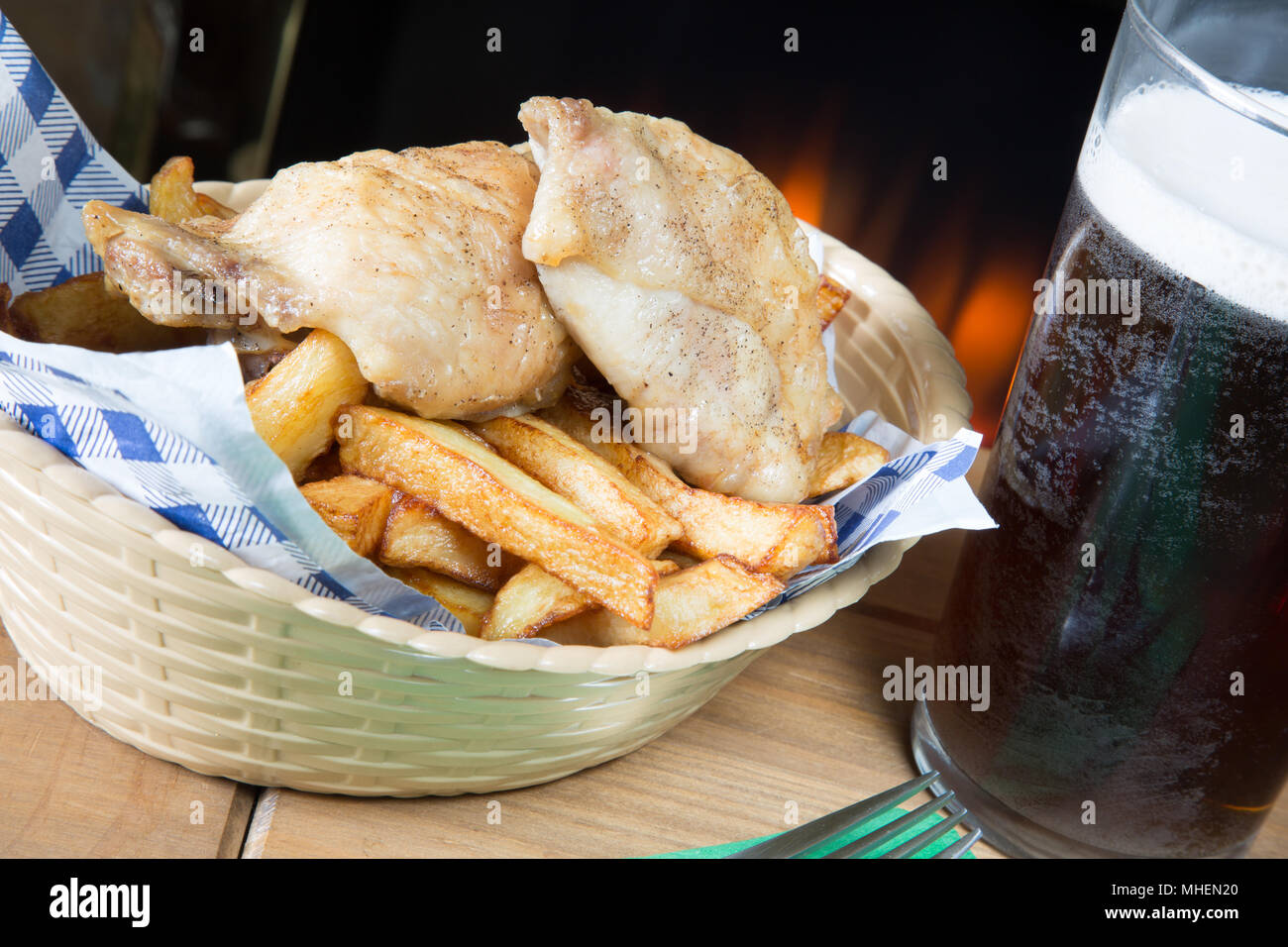A classic English dish of Roast Chicken and chips in a basket Stock