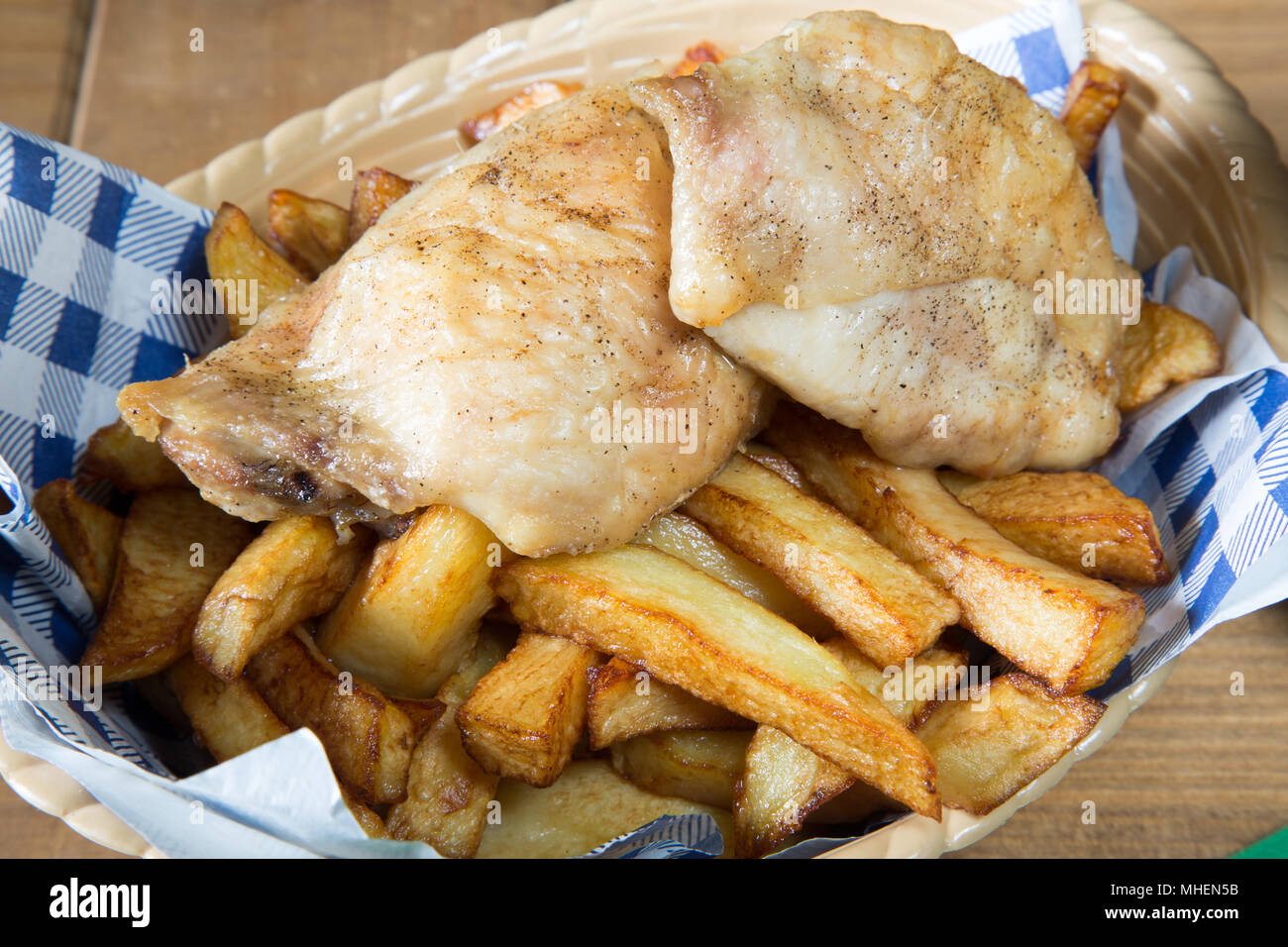 A classic English dish of Roast Chicken and chips in a basket Stock