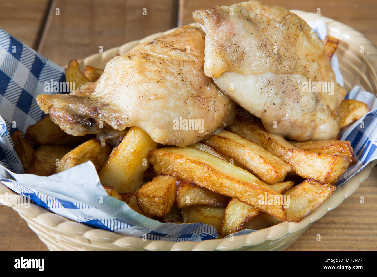 A classic English dish of Roast Chicken and chips in a basket Stock
