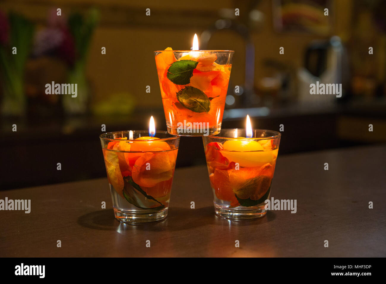 City Jekabpils, Latvia. Candles light and rose leafs inside in glass bowl. Travel photo 2018. Stock Photo