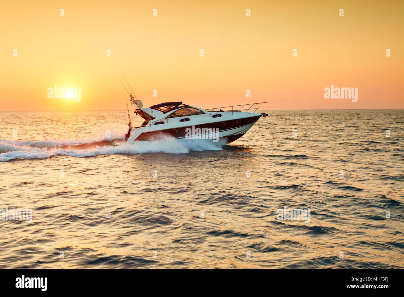 Beautiful sunset at sea. Sea background. Boat Stock Photo - Alamy