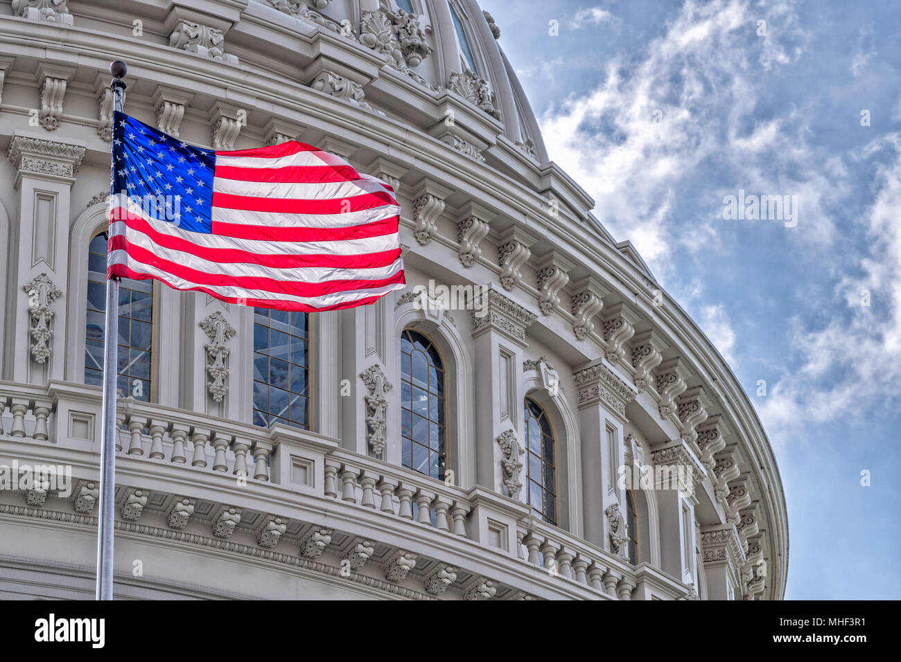 Washington DC Capitol dome detail with waving american flag Stock Photo ...