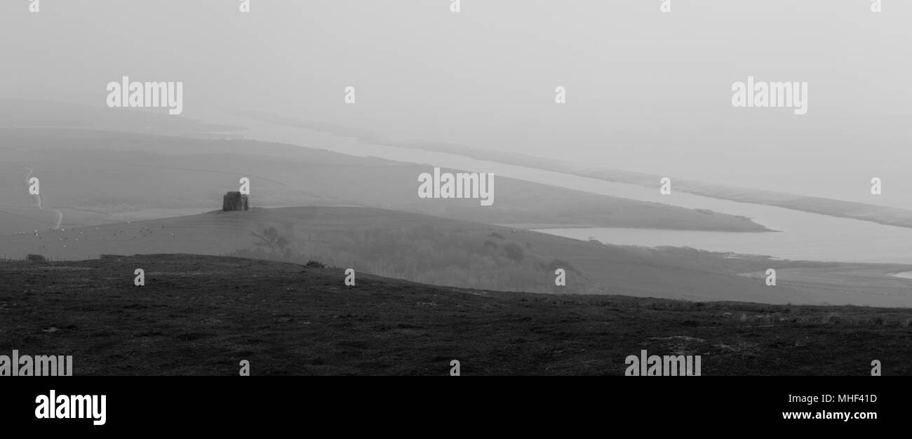 atmospheric picture of Abbey in sea mist on cliff top, looking out towards Portland Bill. Black and White Stock Photo