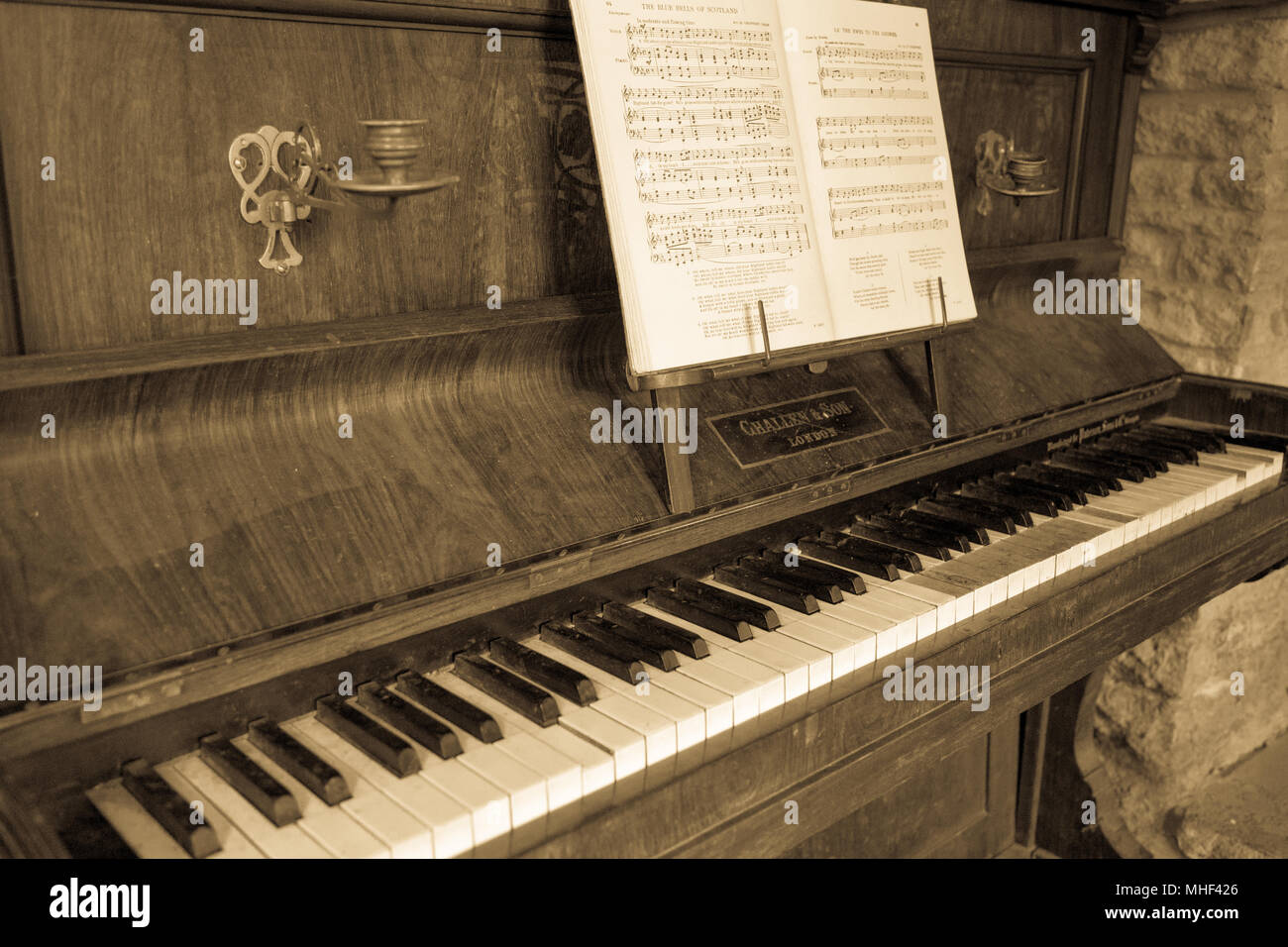 Old broken piano antique Sepia monochrome aged effect Stock Photo