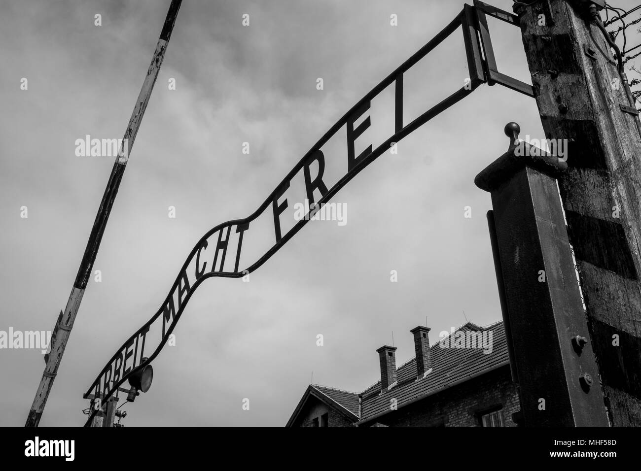 Auschwitz, Poland. Entrance to Nazi Concentration Camp at Auschwitz 1 showing the historical gate with sign saying Arbeit Macht Frei - Work Make Frei Stock Photo