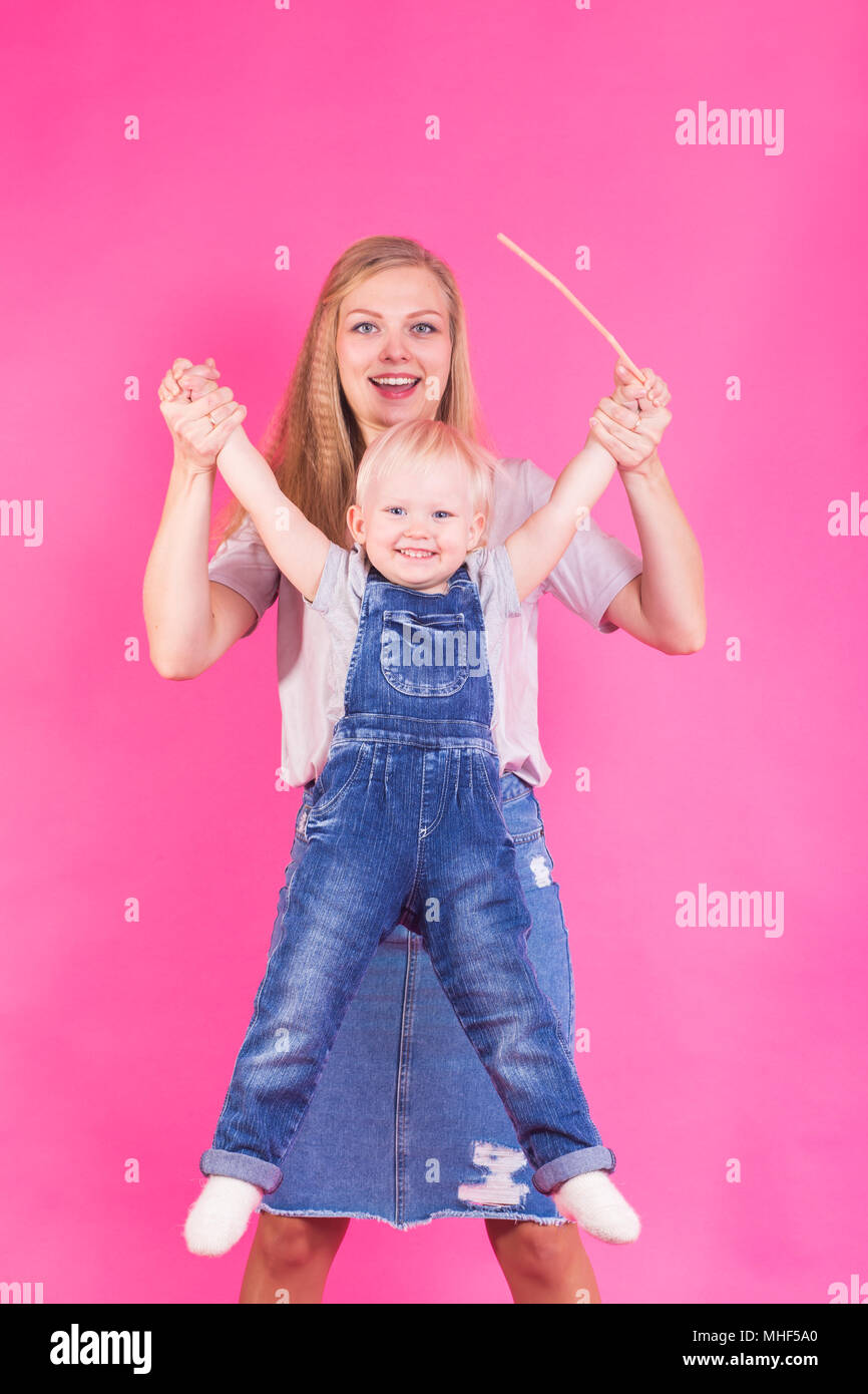 Funny family on pink background. Mother and her daughter girl. Mom and ...