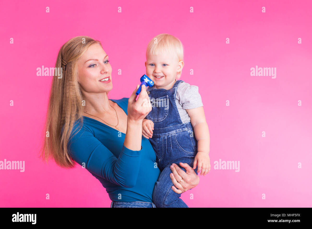 Funny family on pink background. Mother and her daughter girl. Mom and ...