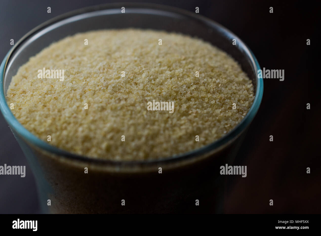 Glass of Raw Unprepared Semolina Flour. Organic Food. Stock Photo