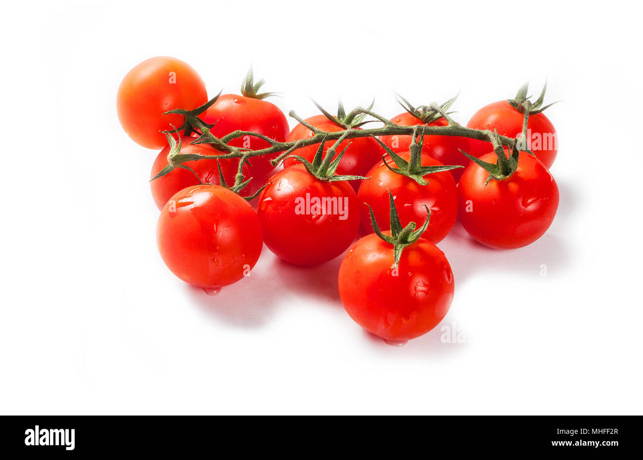 Tomatoes cherry branch isolated on white background Stock Photo - Alamy