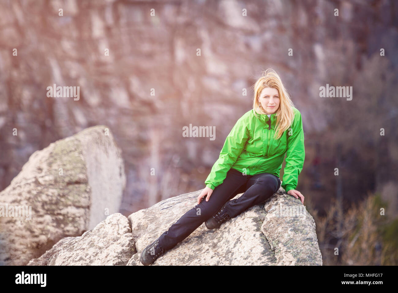 Woman sitting rock cliff hi-res stock photography and images - Alamy