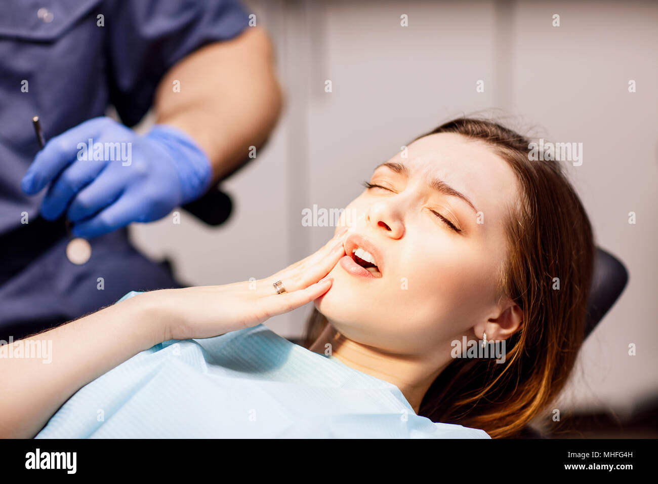 Young woman patient waiting treatment in stomatology clinic. Stock Photo