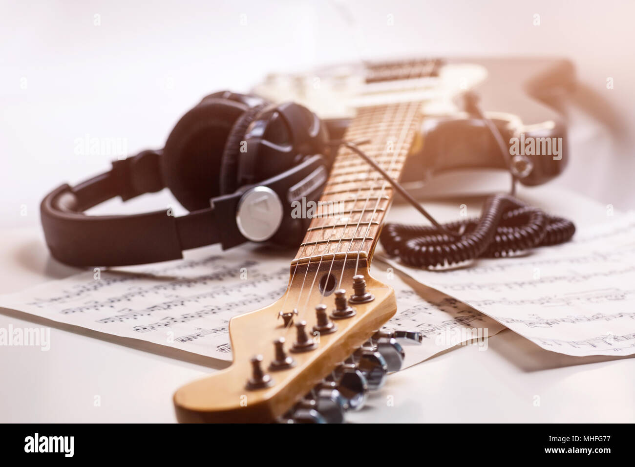 Electric guitar and headphones with music notes. Stock Photo