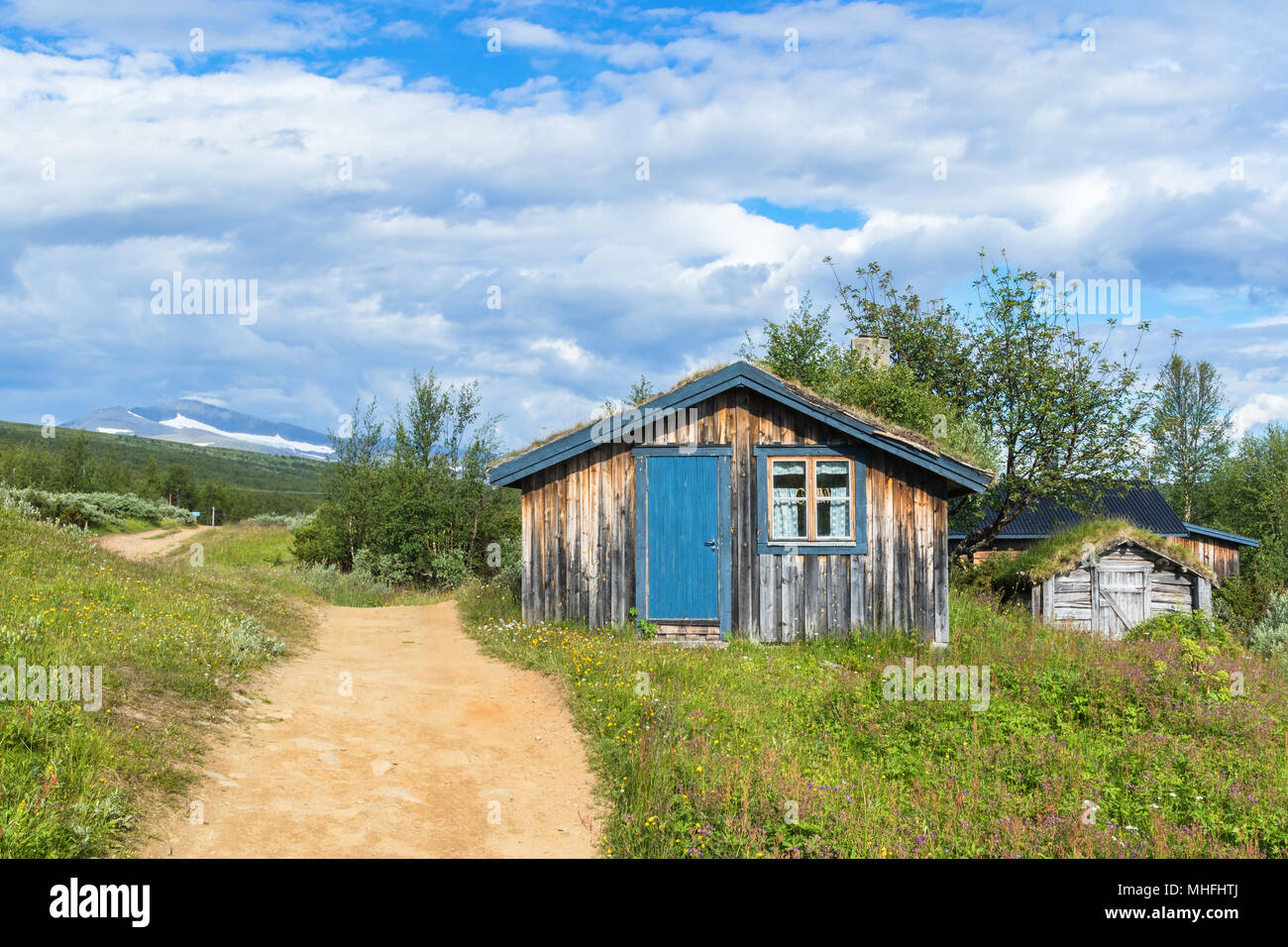Mountain hut at a path in the swedish mountains Stock Photo