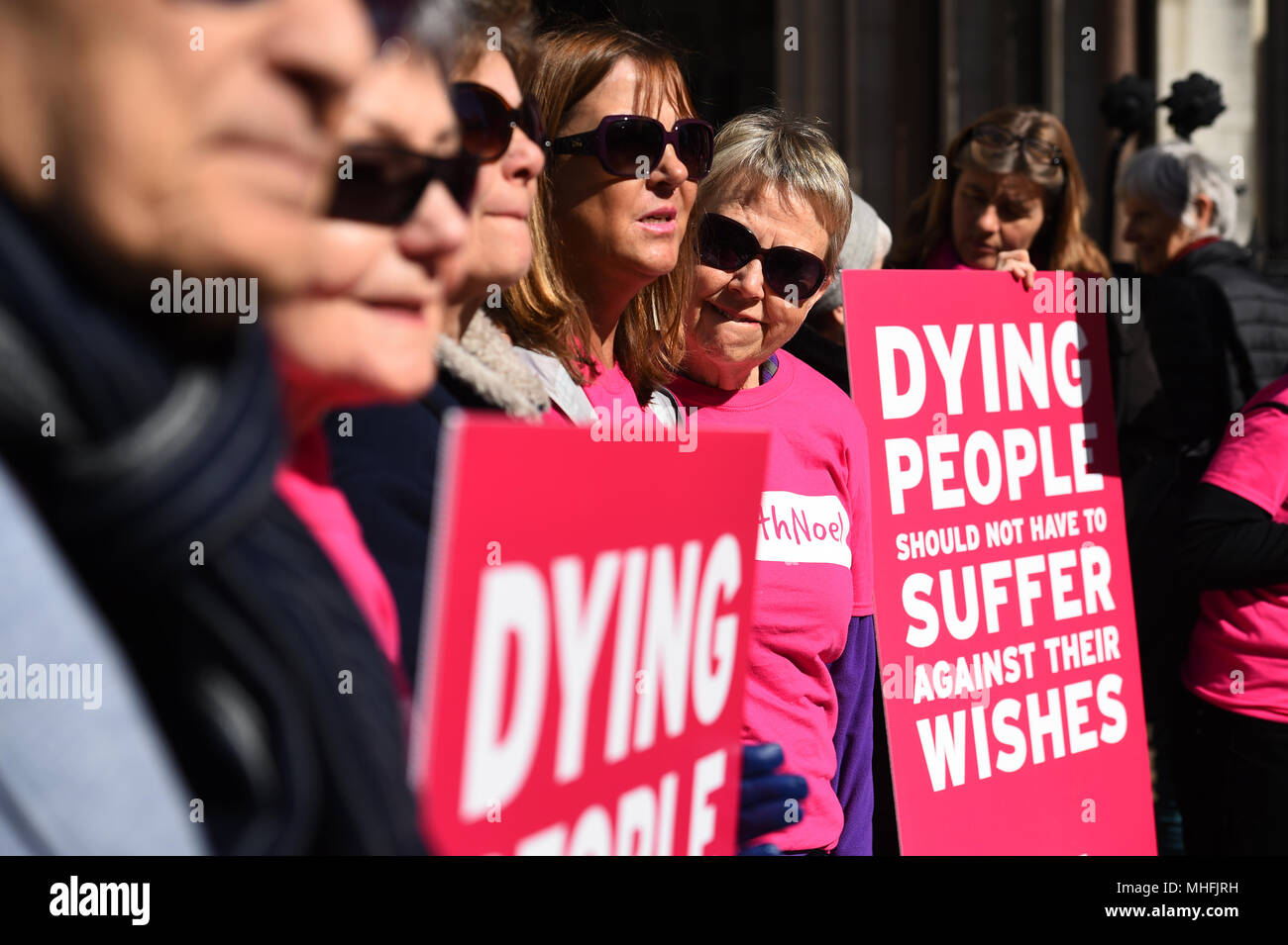 Activists from the Campaign for Dignity in Dying outside the Royal Courts of Justice in London, where motor neurone disease sufferer Noel Conway is to begin an Appeal Court challenge against a 'blanket ban' on assisted dying. Stock Photo
