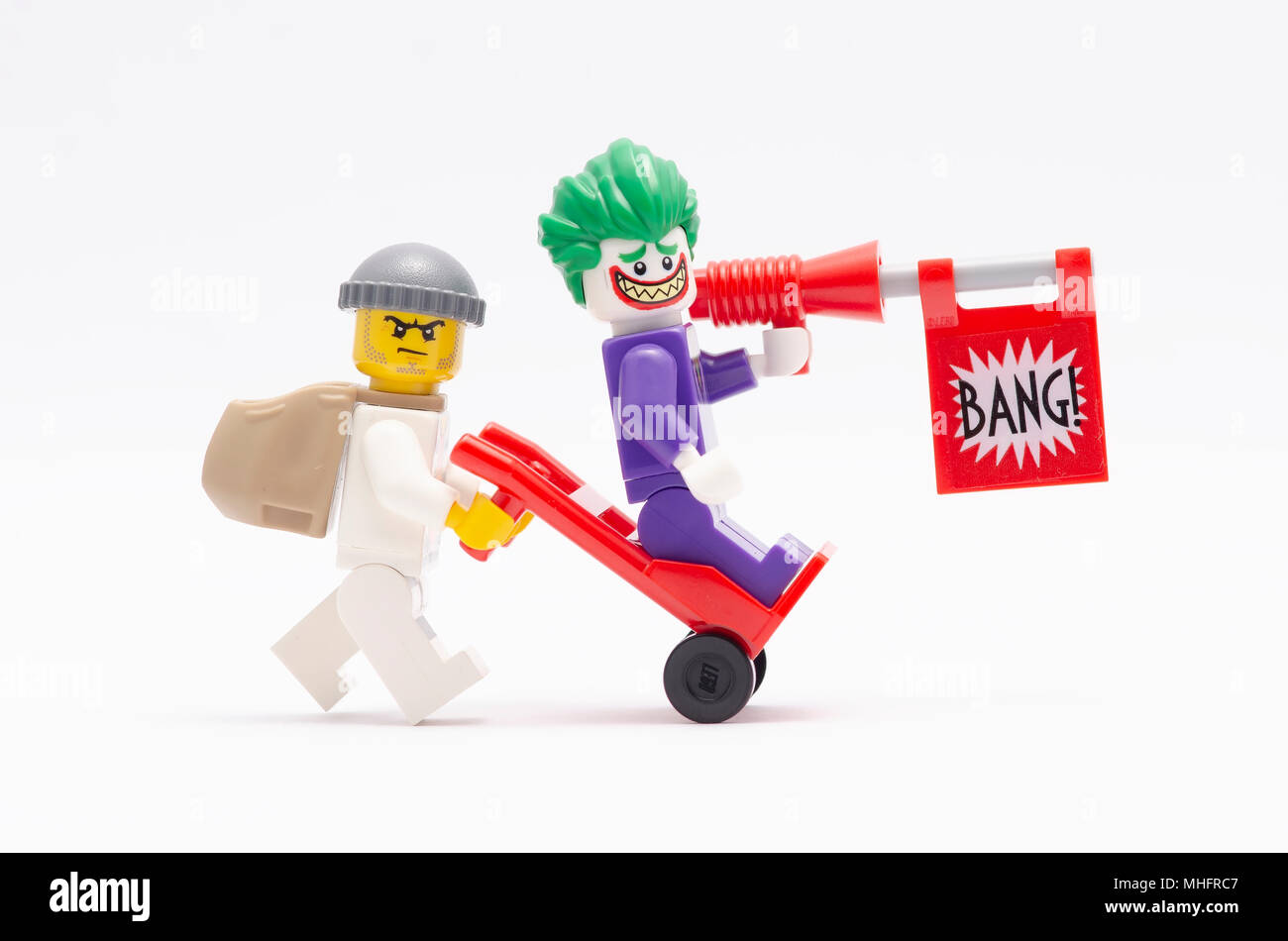 mini figure of man pusing trolley with joker standing on it. Lego  minifigures are manufactured by The Lego Group Stock Photo - Alamy