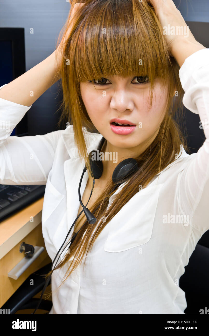 Young tired business woman with headache sitting at computer in ...