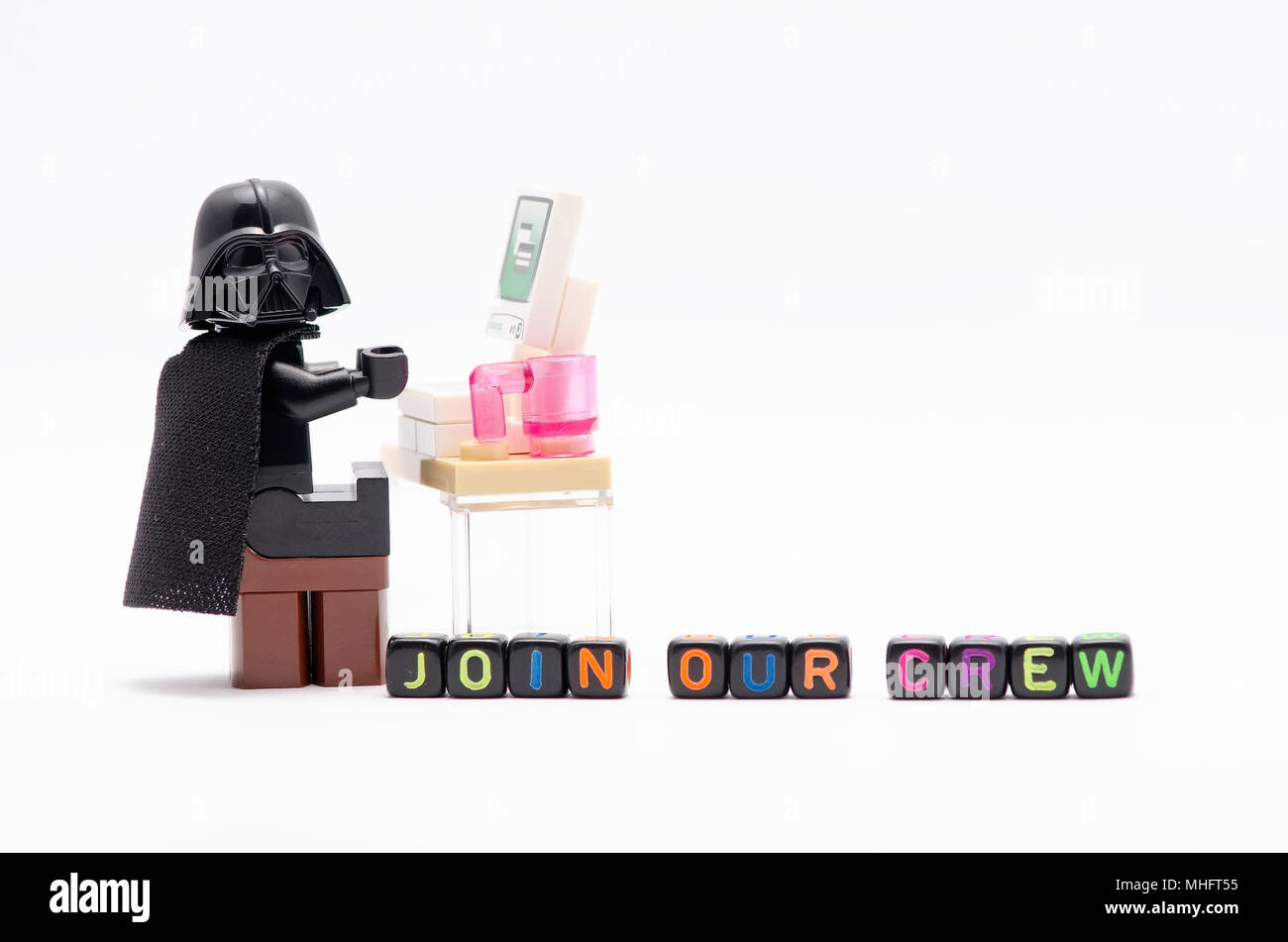 mini figure of darth vader on chair with word join our crew. Lego  minifigures are manufactured by The Lego Stock Photo - Alamy