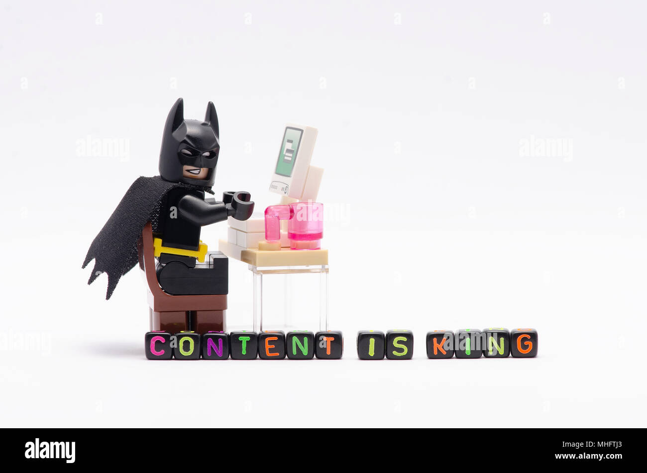 Mini Figure Of Batman On Chair With Word Content Is King
