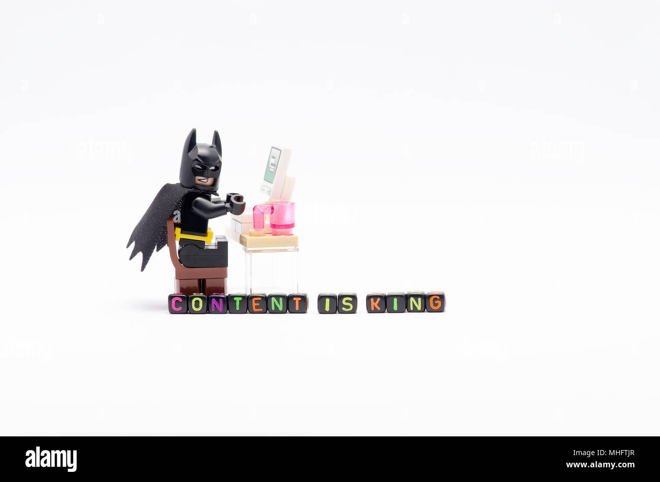 Mini Figure Of Batman On Chair With Word Content Is King