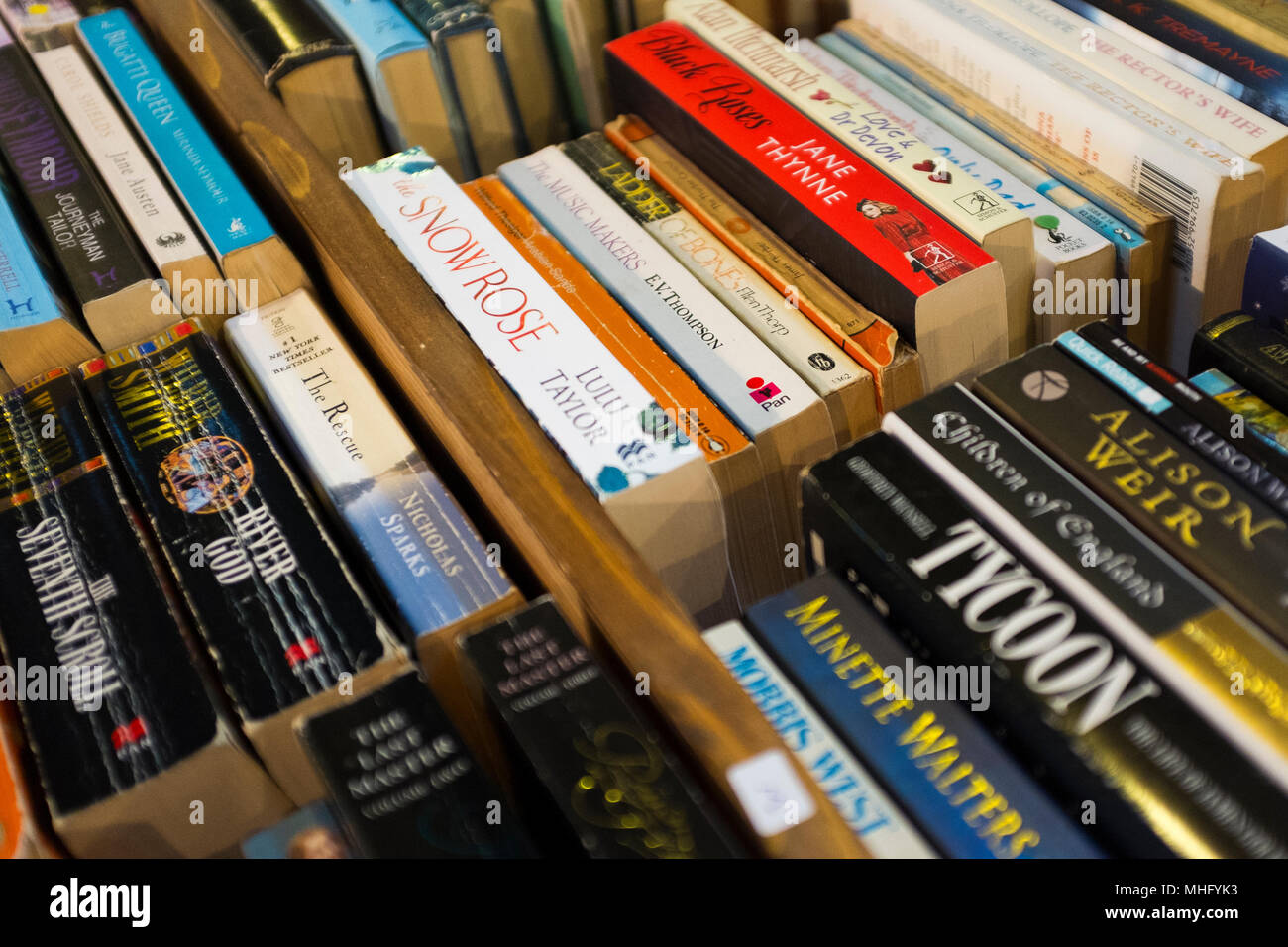 Second hand books stacked in boxes being sold at a church sale in the British town of Malvern, a region of outstanding beauty. Stock Photo