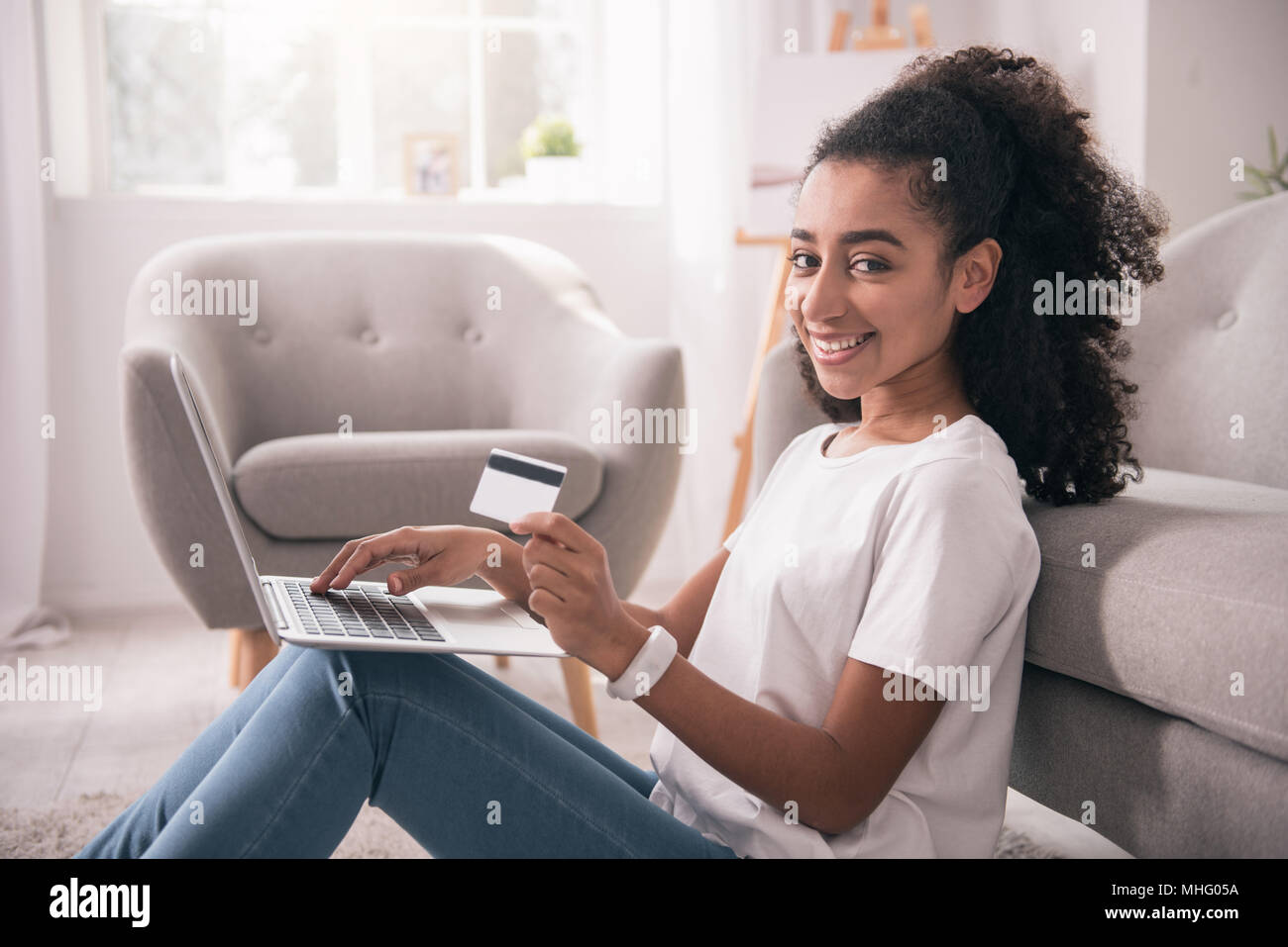 Cheerful happy woman using Internet banking Stock Photo