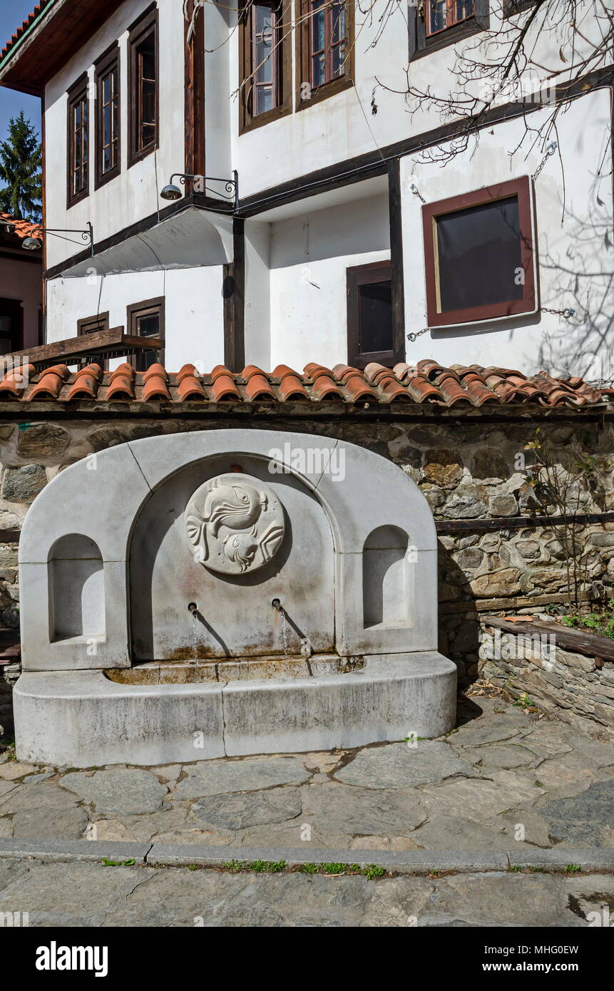 Fresh water gush from  old fountain in the hoary antiquity Varosha, Blagoevgrad, Bulgaria Stock Photo