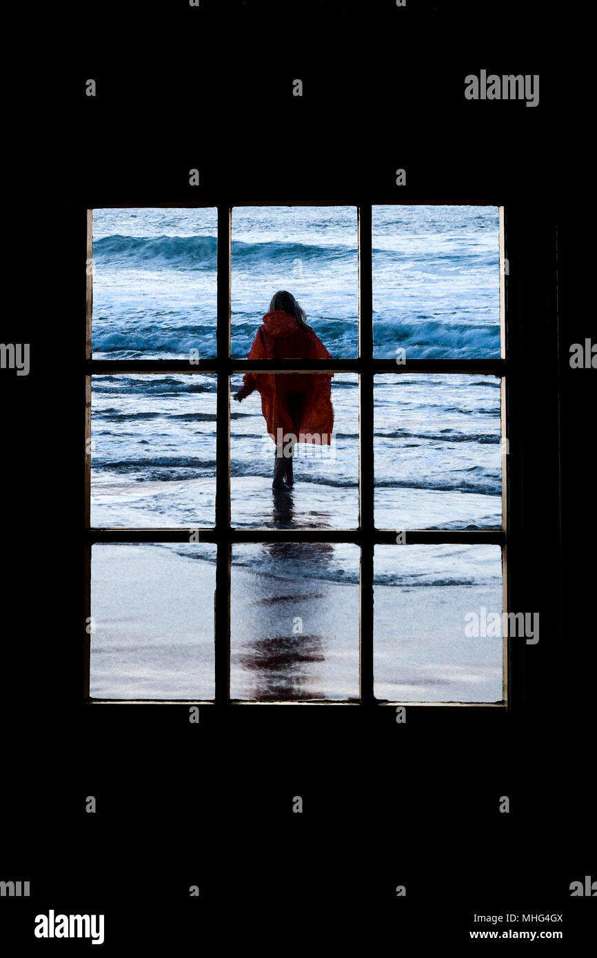 Woman walking into the sea Stock Photo
